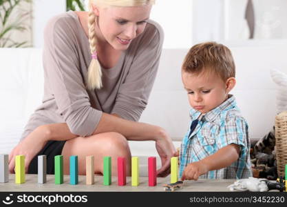 Mother and son playing with domino&rsquo;s