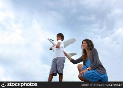 Mother and son playing with plane