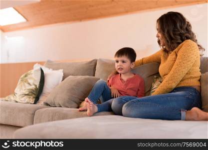 Mother and son relaxing together in the living room