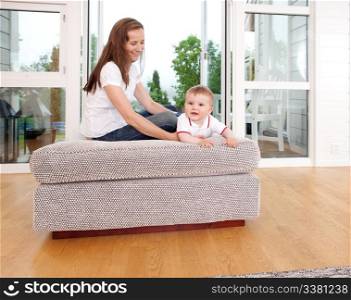 Mother and son sitting in the living room playing