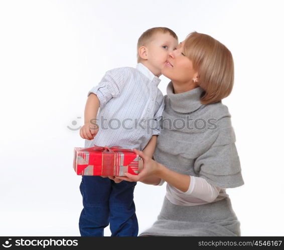 mother and son sitting on the floor and holding a present box