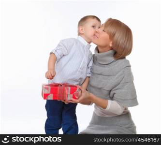 mother and son sitting on the floor and holding a present box