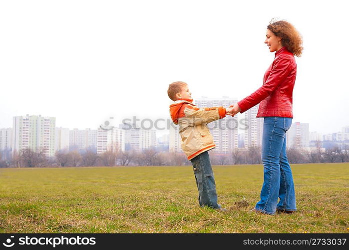 mother and son stand outdoor and look on each other