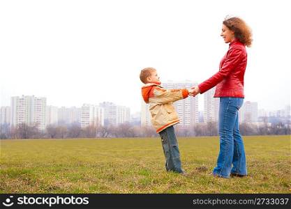 mother and son stand outdoor and look on each other