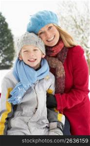 Mother And Son Standing Outside In Snowy Landscape