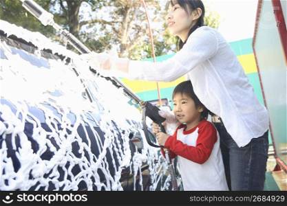 mother and son wash car