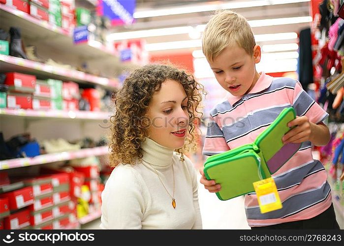Mother and son with green box in shop