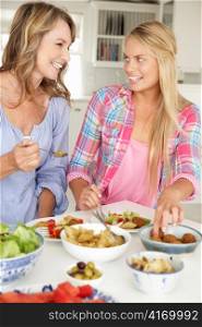 Mother and teenage daughter enjoying meal at home