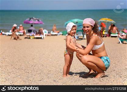 Mother and the child on a beach.