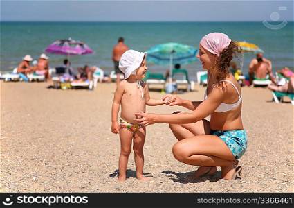 Mother and the child on a beach.