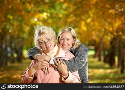 Mother and the daughter embrace in autumn park