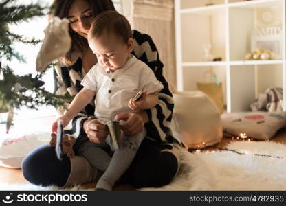 Mother and toddler decorating the Christmas tree.