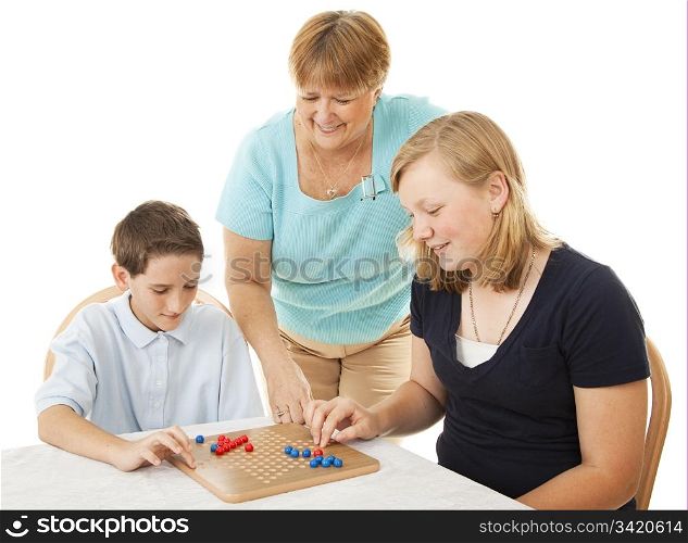 Mother and two children playing board games. Isolated on white.