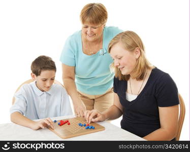 Mother and two children playing board games. Isolated on white.