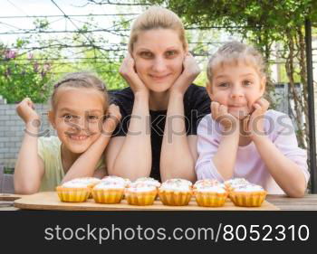 Mother and two daughters have prepared Easter cupcakes