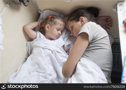 Mother and two year old daughter sleeping on a cot in parlor car trains