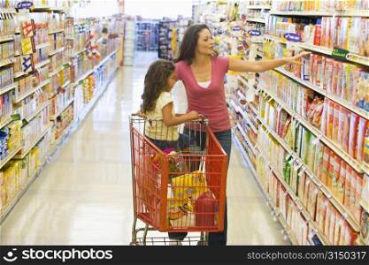 Mother and young daughter shopping at a grocery store