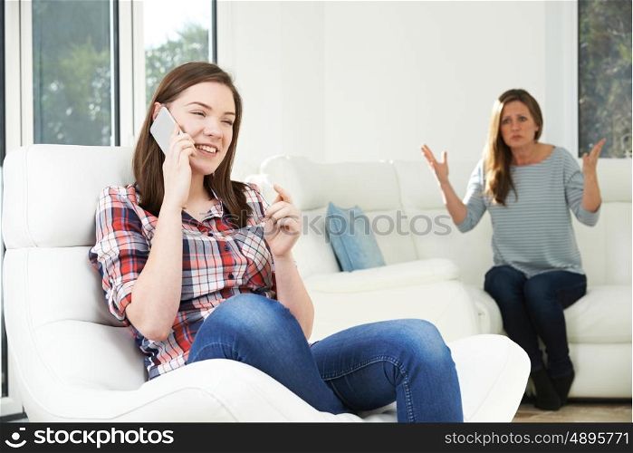 Mother Arguing With Daughter Over Use Of Mobile Phone