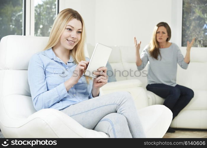 Mother Arguing With Daughter Over Use Of Mobile Phone