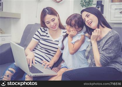 Mother, Aunt and kid having time together lerning with using laptop computer at home with relax and happy on couch, education and lifestyle concept.