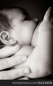 Mother breast feeding her baby close up