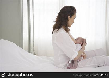 Mother breastfeeding newborn