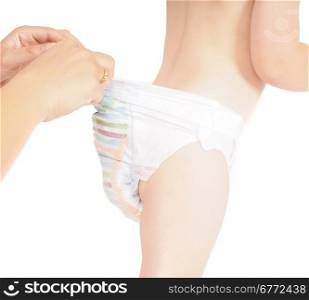 Mother checking pull up diaper pants on restless toddler isolated on white