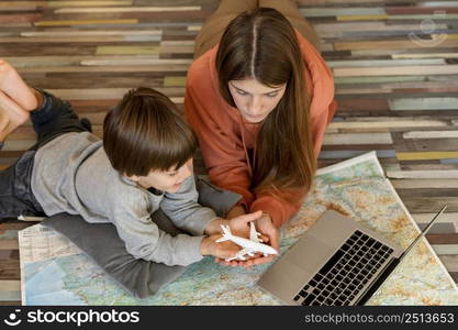 mother child home with laptop map looking place travel