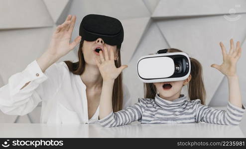 mother child using virtual reality headset being amazed