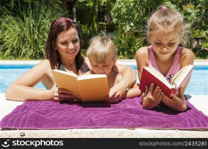 mother children standing pool reading