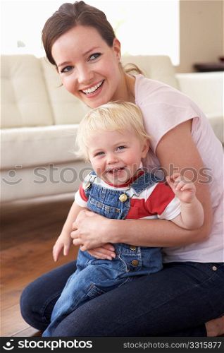 Mother Cuddling Son At Home