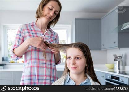 Mother Cutting Teenage Daughters Hair At Home During Lockdown