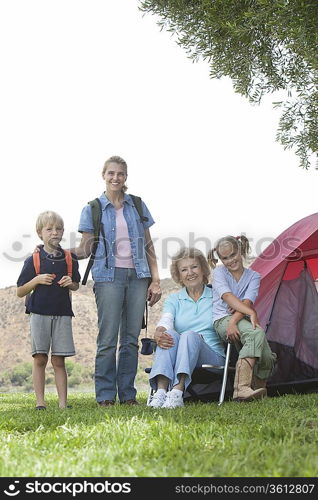 Mother daughter and grand-children outside tent