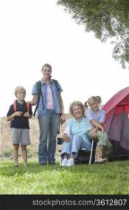 Mother daughter and grand-children outside tent