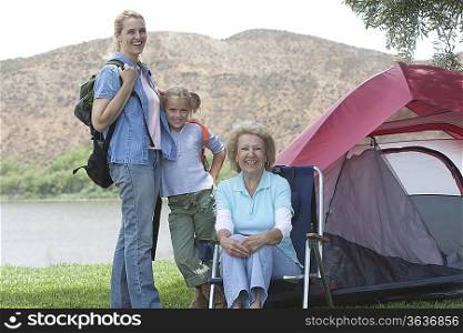 Mother daughter and grand-daughter outside tent