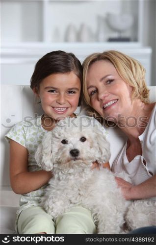 Mother, daughter and white dog