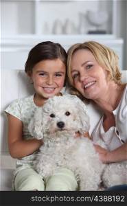 Mother, daughter and white dog
