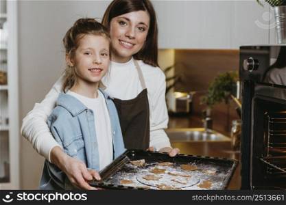 mother daughter baking cookies together