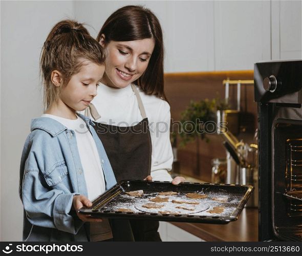 mother daughter baking cookies together home