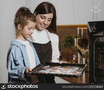 mother daughter baking cookies together home