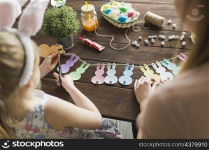 mother daughter cutting bunnies from paper