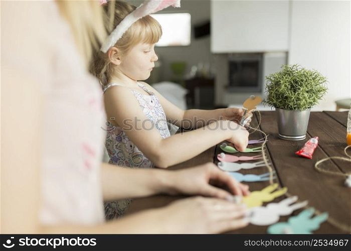 mother daughter cutting garland