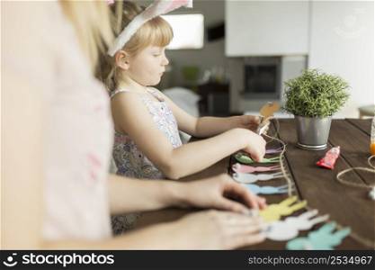 mother daughter cutting garland
