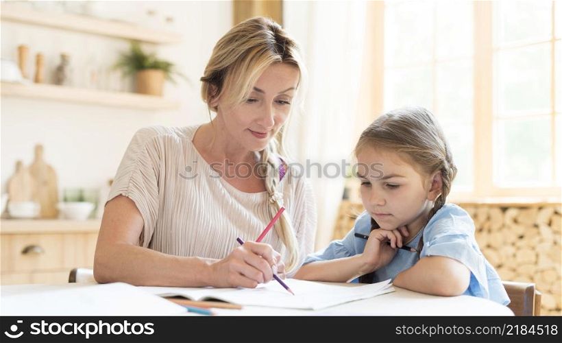 mother daughter doing homework home