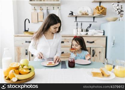 mother daughter having breakfast_2