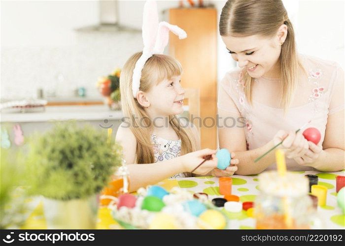 mother daughter painting eggs