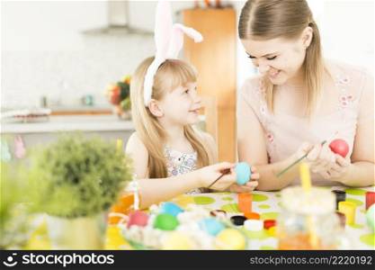 mother daughter painting eggs