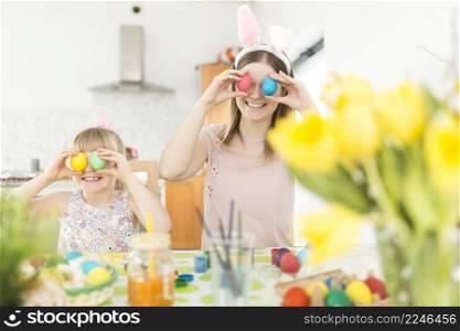 mother daughter posing with easter eggs