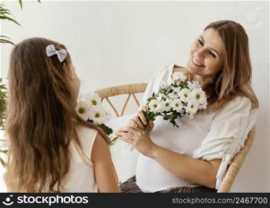 mother daughter with bouquet spring flowers