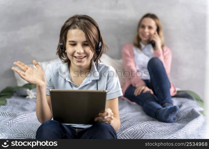 mother daughter with devices